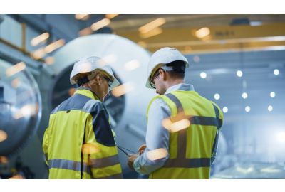 Image of manufacturing workers reading notes.