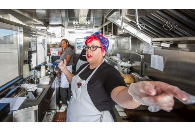 Woman working in a commercial kitchen.