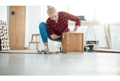 Woman creating a wooden box.