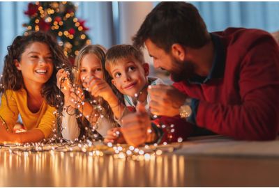 Family untangling Christmas lights.