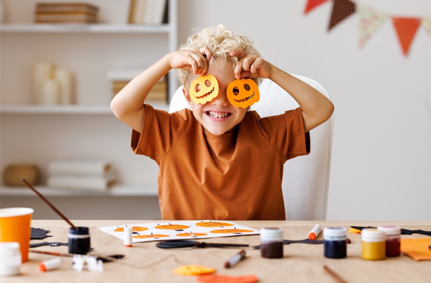 boy making Halloween decorations
