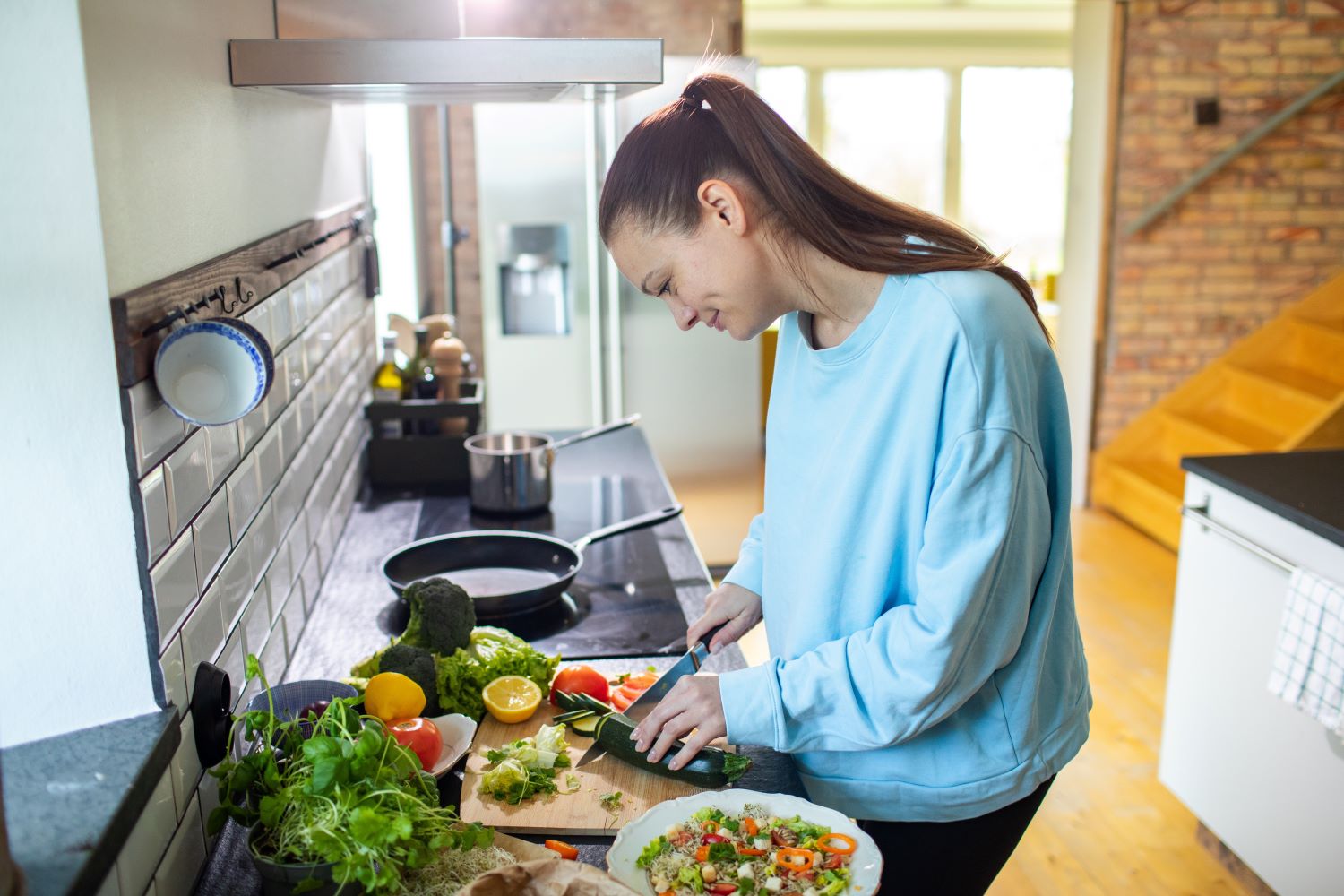 Women meal prepping food.